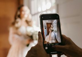 Guest taking a photo at wedding